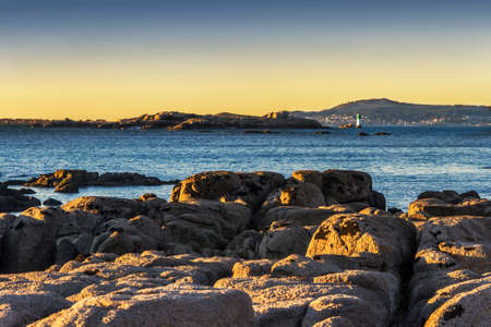 Pomberiro rocky island at O Grove coast at sunsetの写真素材