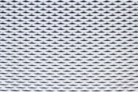 Perforated metal surface background and textureの写真素材