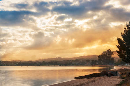 Cloudy and misty sunrise from Sinas beach in Vilanova de Arousaの写真素材