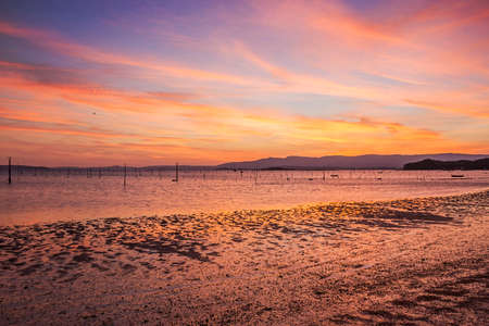 Carril clam aquaculture ponds on Compostela beach, Vilagarcia de Arousa at colorful duskの写真素材