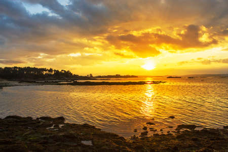 Storm over Arousa Estuary on Vilanova de Arousa coast at golden sunset