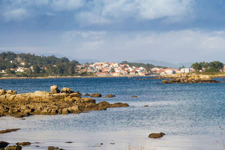 Coastal rocks and Arousa Island village