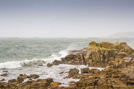 Windstorm and rain on the sea of Arousa island rocky coast, Galicia, Spainの写真素材