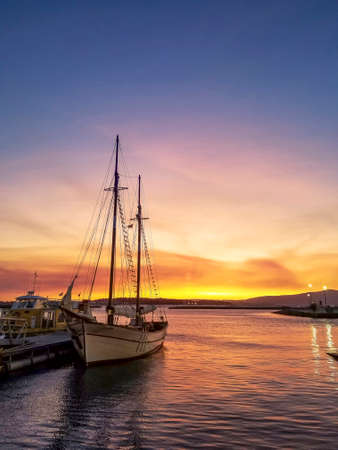 Moored sailboat in Vilanova der Ã„rousa harbor at golden dusk