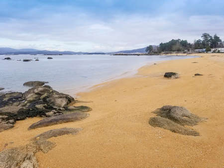 Granite rocks and shore of Campamento beach in Vilanova de Arousa, Galicia, Spain