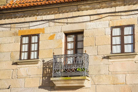Old balcony and windows in stone buildingの写真素材