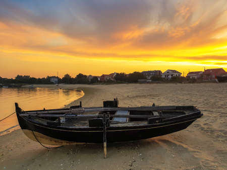 Dorna traditional fishing boat at golden dusk on Riason beach in Arousa Island, Galicia, Spainの写真素材