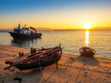 Fishing boats on Furado beach in Arousa Island at sunriseの写真素材