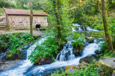Waterfall and watermill in Armenteira river on the stone and water route in Meis town, Galicia, Spainの写真素材