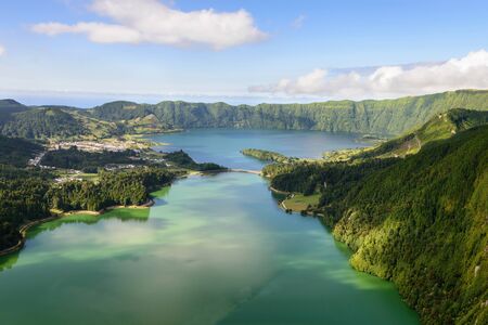 Amazing Azorean landscape. Panoramic view of the lake of Sete Cidades, Azores, Portugal. Viewpoint Vista do Rei at Sao Miguel. The Azores are one of the main tourist destinations in Portugalの写真素材