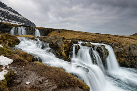 Amazing Icelandic landscape at the top of Kirkjufellsfoss waterfall with Kirkjufell mountain in the background on the north coast of Iceland Snaefellsnes peninsulaの写真素材
