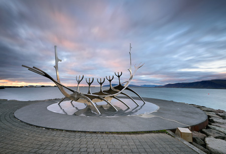 Icekand, Solfar at sunset. Sun Voyager monument, landmark of Reykjavik city with sea and mountains in background, Icelandの写真素材