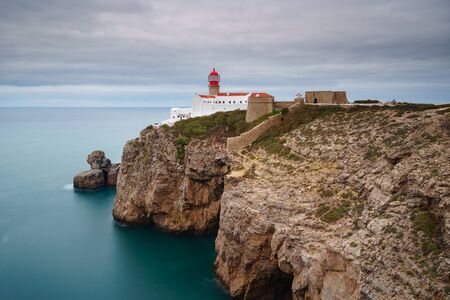 Landscape of the lighthouse and cliffs at Cape St. Vincent at sunset. Algarve amazing seascape.  Continental Europe's most South-western point, Sagres, Portugal.の写真素材