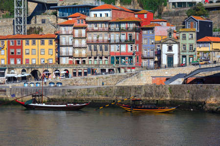 Porto, Portugal panoramic cityscape on the Douro River at sunset. Urban landscape at sunset with traditional boats of Oporto city. Downtown and historic center, travel destination. Oporto landmark.のeditorial素材