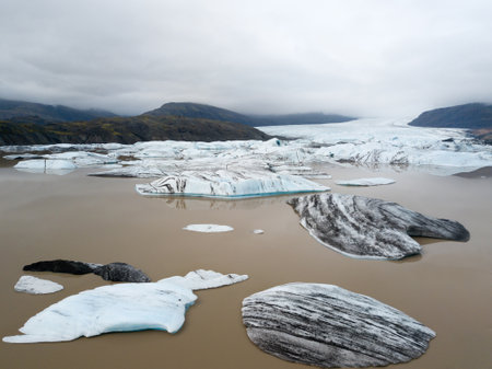 Jokulsarlon glacier lagoon, Iceland at sunset. Beautiful iceberg flow through the mountains. Cold...