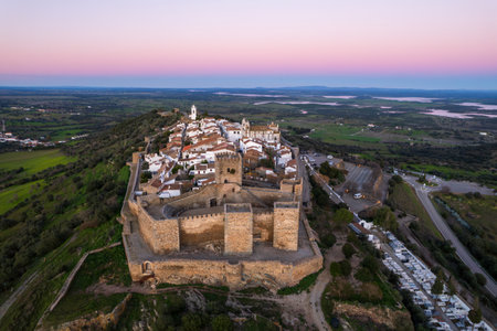 Amazing aerial view of the medieval village of Monsaraz, Alentejo, Portugal. Beautiful landscape at sunset. Historic castle, tourist attraction and holiday travel destination.の写真素材