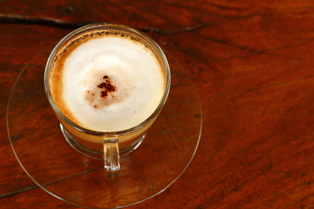 Top view of a paper cup of black coffee on wooden tableの写真素材