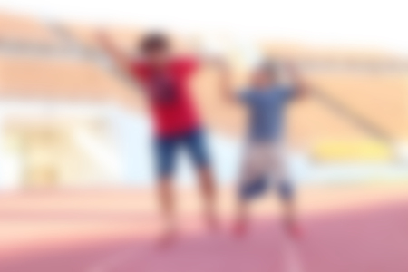 Blur Woman and boy jumps at the stadiumの写真素材