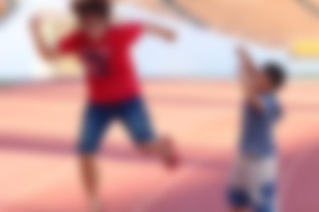 Blur Woman and boy jumps at the stadiumの写真素材