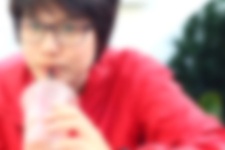 blurred woman drinking iced cocoaの写真素材