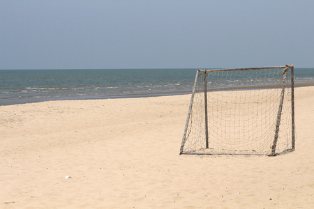 Empty rusty goal in a sand soccer fieldの写真素材