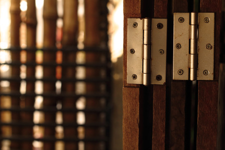 Old door hinge on wooden door.の写真素材