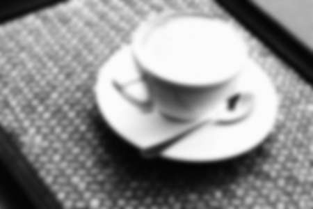 Blur A cup of hot cappuccino coffee in the wood tableの写真素材