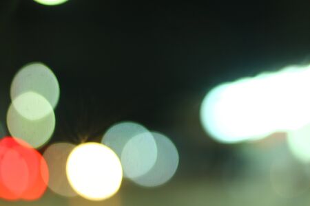Blurred bokeh of car in city at night