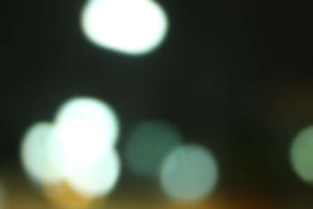 Blurred bokeh of car in city at night