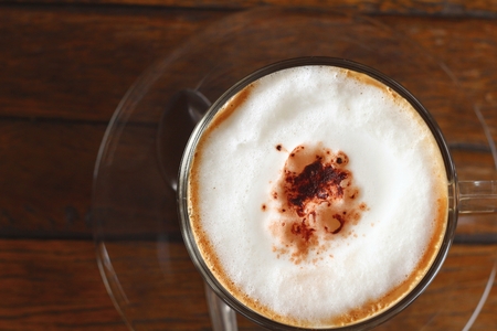 A cup of hot latte coffee in gardenの写真素材