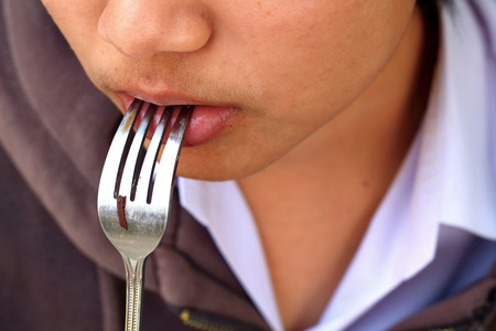 Portrait of mouth eating chocolate black forestの写真素材