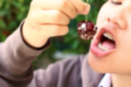 Blur Portrait of mouth eating red cherry