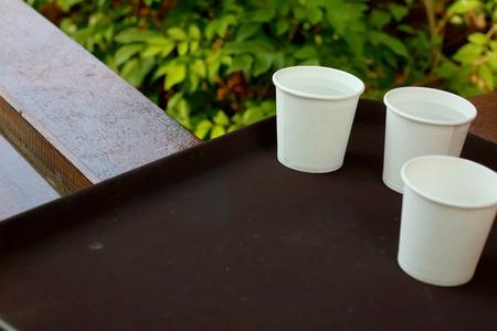 Glass of Water on Wood Tray Coffee Shop Tableの写真素材