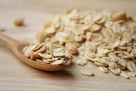 Blur Oat flakes in wooden scoop on wooden background ,Vintage style