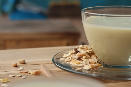 Oat flaks on a wooden spoon and glass of milk. ,Vintage styleの写真素材