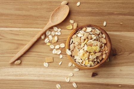 Oat flakes in wooden scoop on wooden background ,Vintage style