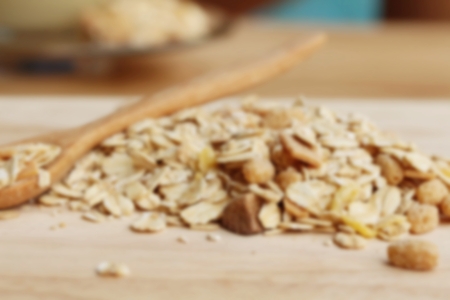 Blur Oat flakes in wooden scoop on wooden background ,Vintage style