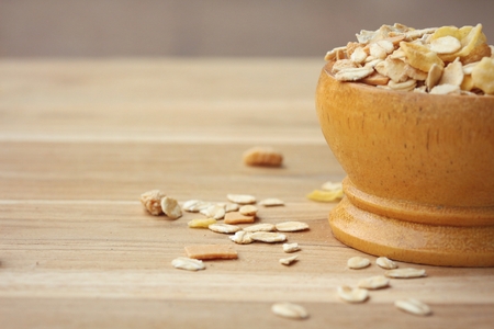 Oat flakes in wooden scoop on wooden background ,Vintage style