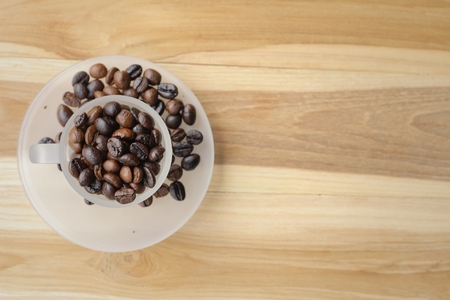 Cup of coffee and coffee beans on wooden background.の写真素材