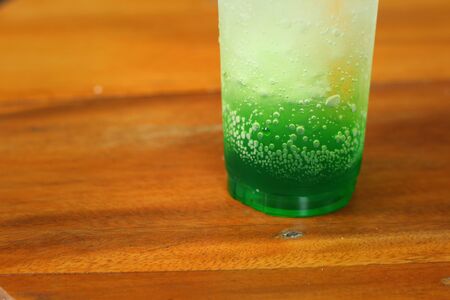 Green fruit with soda water on a table