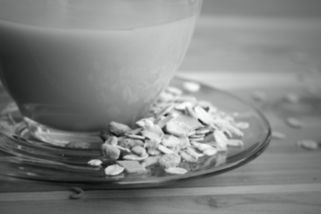 Blur Oat flaks on a wooden spoon and glass of milk. ,Vintage styleの写真素材