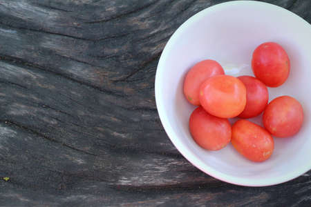 Fresh tomatoes on rustic wooden backgroundの写真素材