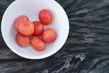 Fresh tomatoes on rustic wooden backgroundの写真素材