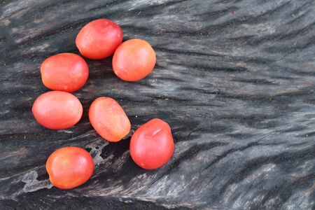 Fresh tomatoes on rustic wooden backgroundの写真素材