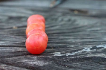 Fresh tomatoes on rustic wooden backgroundの写真素材