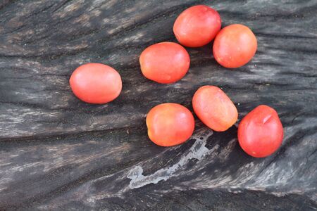 Fresh tomatoes on rustic wooden backgroundの写真素材