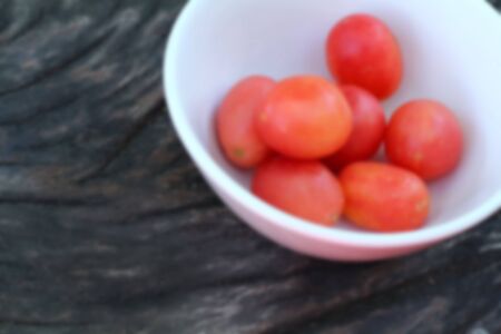 Blur Fresh tomatoes on rustic wooden backgroundの写真素材