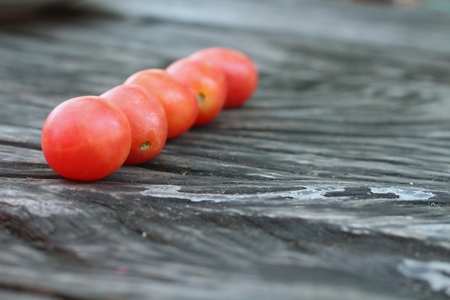 Fresh tomatoes on rustic wooden backgroundの写真素材