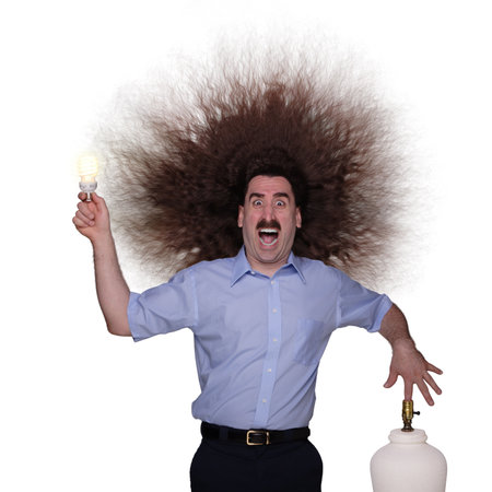 Electrocuted long haired man changing a lightbulbの写真素材