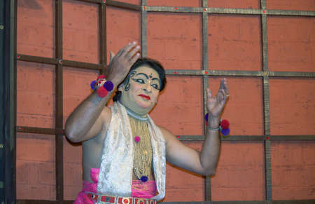 Kochi, India - March 15, 2014: An Indian classical dance form named Kathakali artists tells Indian mythological stories through numerous gestures techniques and emotions in front of several European tourists.のeditorial素材